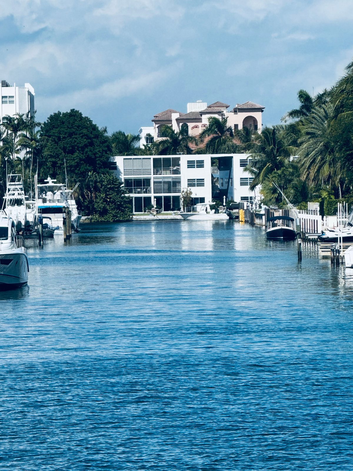 Waterfront homes and docked boats along a Fort Lauderdale canal on a sunny day