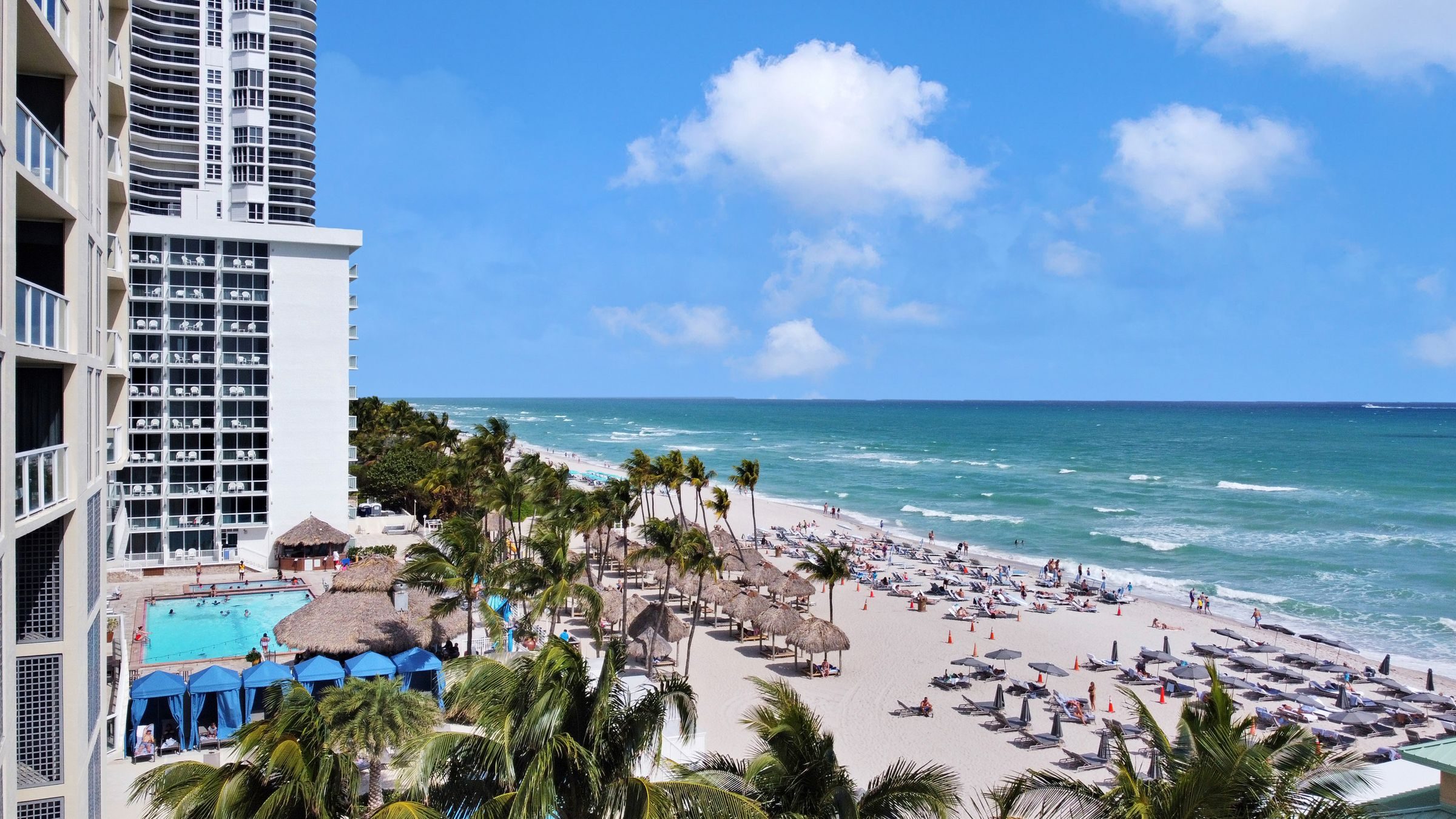 Oceanfront resort pool, cabanas and beach in Sunny Isles Beach