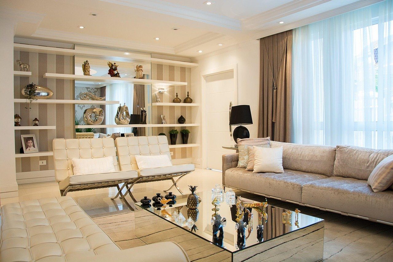 Styled living room: linen sofa, mirrored coffee table and warm light