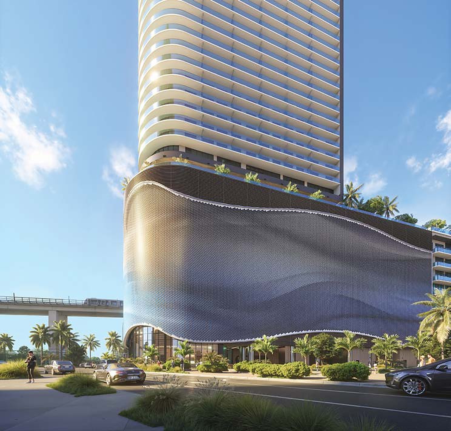 The tower’s street-level arrival beneath the curved podium