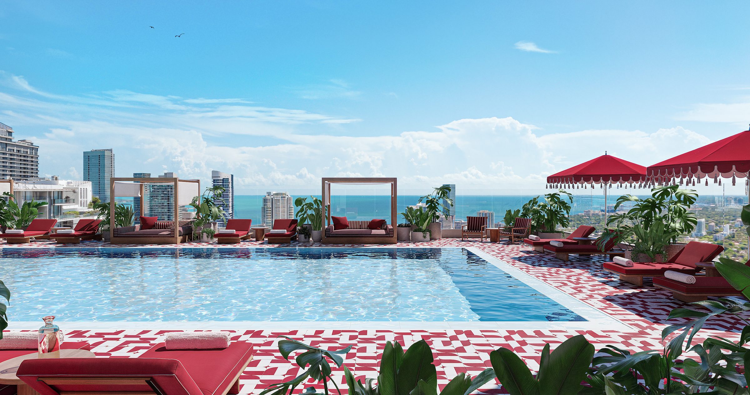 The rooftop pool deck with cabanas, red umbrellas and views over Brickell to the bay